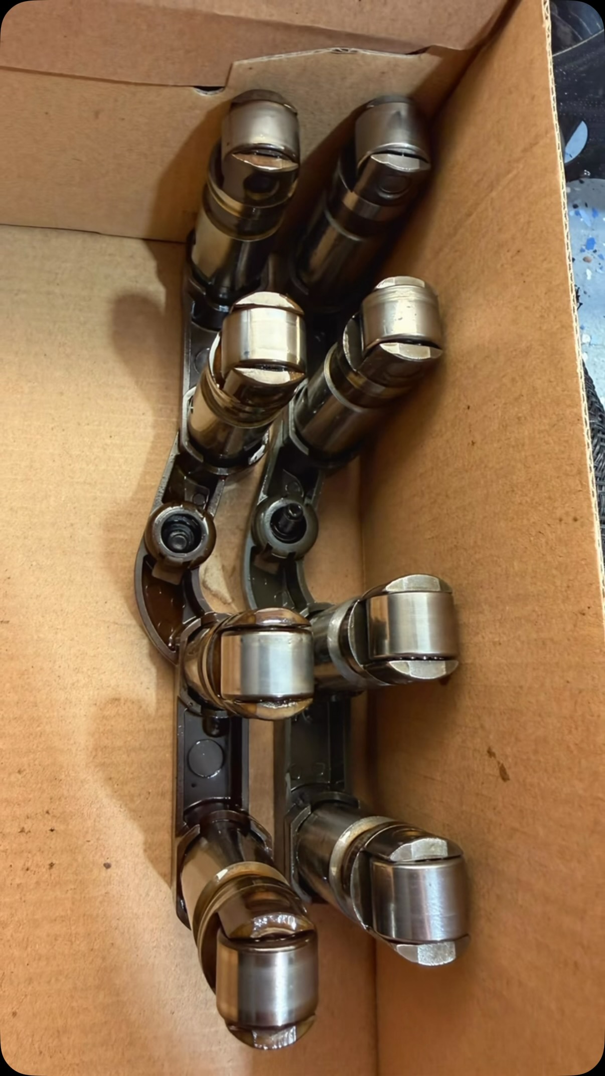 Box of HEMI lifters and engine parts ready for a tick repair